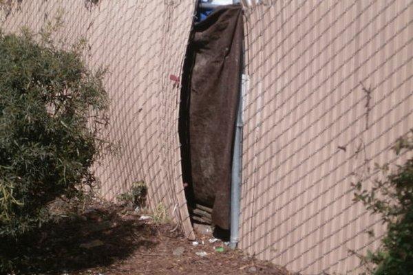 Hole in fence, same area. Gone unrepaired for many months.