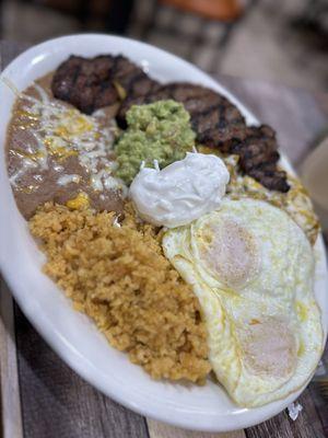 Chilaquiles green sauce, steak and a sunny side egg