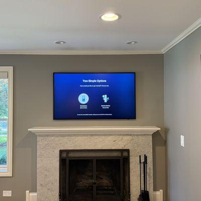55 inch Samsung Frame TV installed over the fireplace with the One Connect box hidden behind the TV.