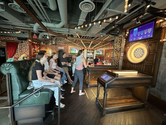 A group of 9 in a booth next to an empty booth