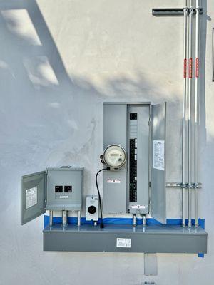 See how the gutter (the rectangular electrical box at the bottom) lines up to the left with the solar inverter sub-panel at the left.