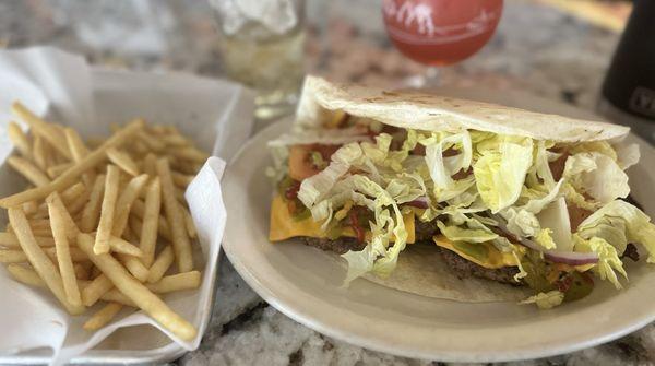 amazing dez burger in tortilla with green chile strips, tomato, onion, lettuce, extra patty, fries, adult frozen fruit punch