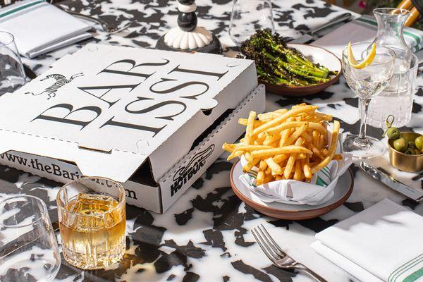 A Pizza Box, french fries and a cocktail