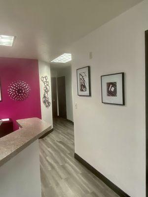 As you walk in main room with hallway leading back to office and machine room