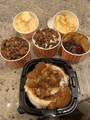 Stuffed Cinnamon Roll front Peach Praline Cobbler left side Bourbon Pecan Banana Pudding middle Blackberry Peach Cobbler right side