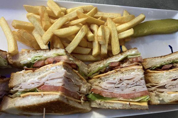 Triple-decker, turkey club sandwich. Choice of fresh toast. Fries, the pickle upon request..