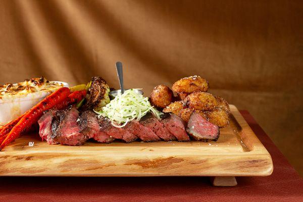 Dry Aged Steak for Two, craft with house aged steak, cauliflower cheese, roasted carrots, cabbage, pub potatoes, and veal demi