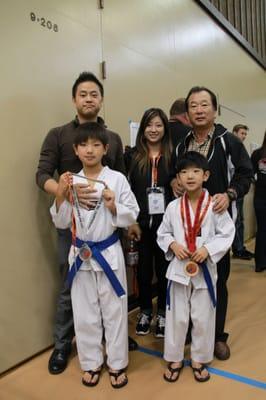 Master Park, Master Liz Koo, and Grandmaster Koo shown with Junwon and Eric!