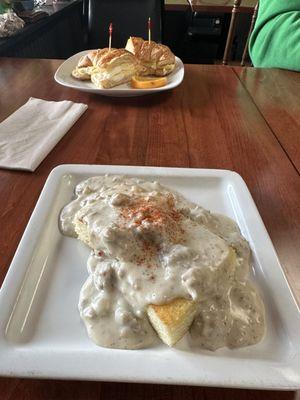 Background - croissant egg sandwich, foreground - half order of biscuits and gravy.