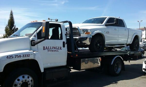 Towing a brand new Heavy Duty Dodge Ram 2500 on one of our full size Flatbed trucks!