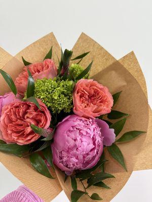 Pink peonies, coral roses, green mini hydrangea, pink Veronica, Italian ruscus hand tied bouquet.