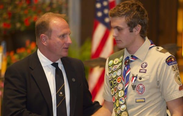 Jack Dhamer congratulating his son during his Eagle Scout Ceremony at St. Therese Church in Deephaven, MN