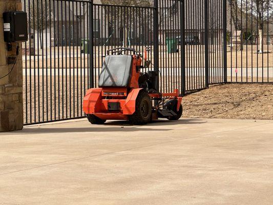 The big boy mower that he brought to mow the backyard once the aeration was complete so that he could break up the dirt plugs