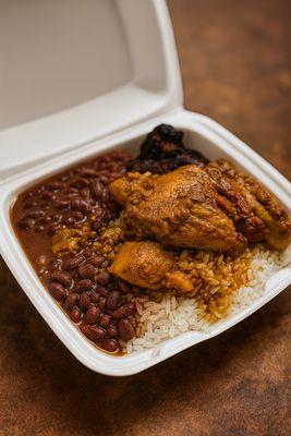 Takeout Belizean-style stew chicken served with hearty red beans and white rice, packed with deep, savory flavors.