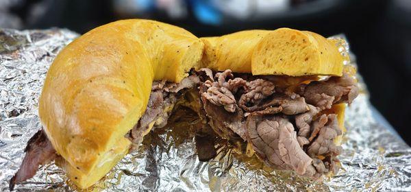 Roast beef egg and cheese on a toasted egg bagel