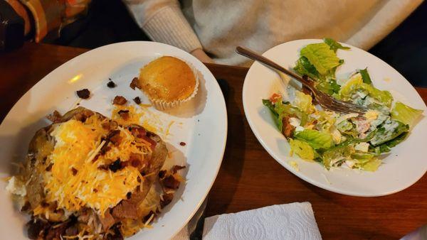 Baked potato loaded with brisket and a salad