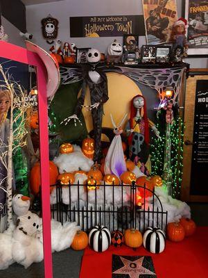 Barbie station with props to take photos with and a Halloween town jack Skellington movie prop