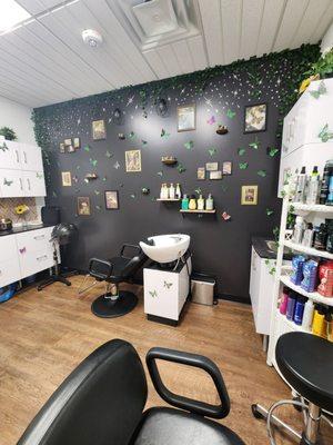 Black wall with butterflies and mushroom decor and gnomes and fairies and frogs