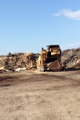 Old Pallets recycled and ground being prepared for mulch!