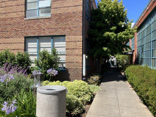 When you walk through the gate make a left down the pathway it is the first door on the left.