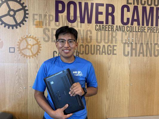 Hunter is showcasing the laptop he received as a RISE Scholars scholarship