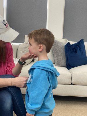 A mom consoling her son on why this photo will be pulled out at family Christmas gatherings for the next 35 years.