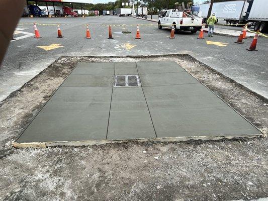 Concrete poured around a catch basin at a Fuel Station.