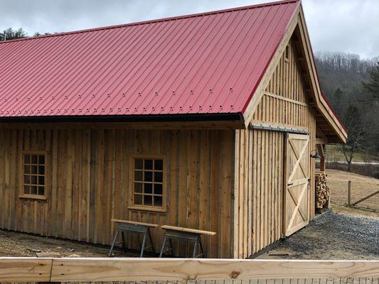 Snow and ice guards installed with this new red metal roof by Southern Quality Company.