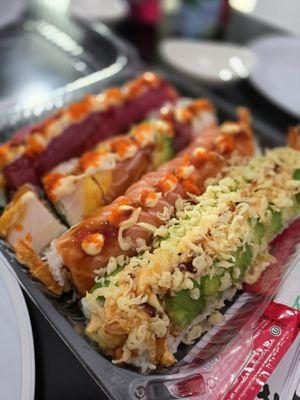 Assorted packed special sushi rolls to go.