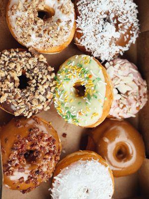 Vanilla pecan, maple coconut, cherry almond, lemon, chocolate walnut, vanilla coconut and maple donuts.