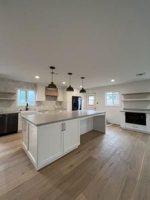 Tom built us all of our kitchen cabinets, island and coffee bar with floating shelves and custom wood hood