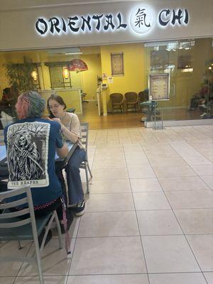 The store front of this business facing the food court