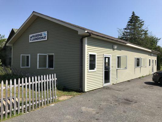 This unassuming building is the laundromat.However, the sign is facing the grocery store, not Elm street so be careful not to drive by.