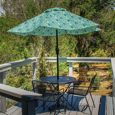 The Panorama Room's private river deck with umbrella and bistro table