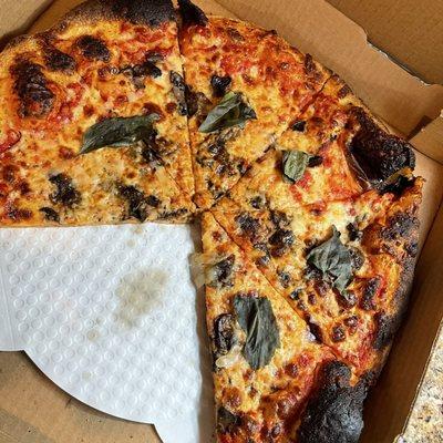 Problem Child Pizza. Burnt with skimpy toppings.