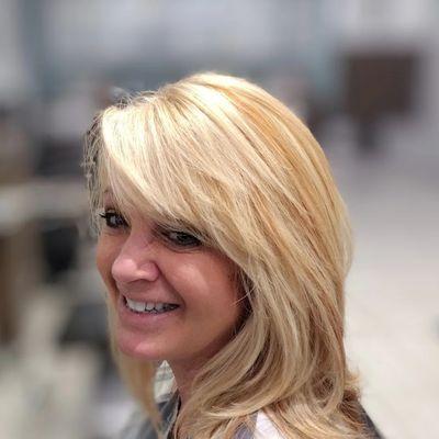 Sun kissed blonde foil highlight lowlight color blocking the back . Hair cut blow dry