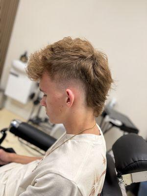 High faded, layered Mohawk for wavy/curly hair by Patrick