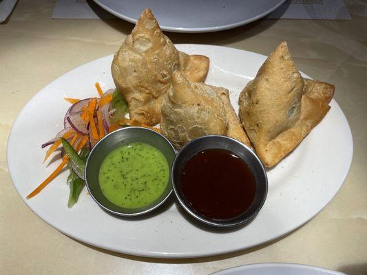 Vegetable samosas with slightly spicy, mint chutney and sweet, smooth, rich, tamarind, chutney