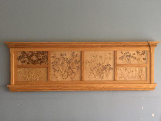Pressed plant curio display constructed of white ash.