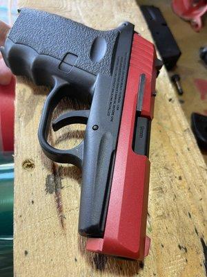 SCCY coated in habanero red and barrel in micro slick low friction