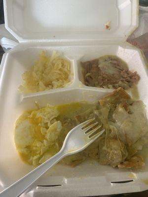 Chilaquiles verdes with over medium eggs, hash browns and beans.