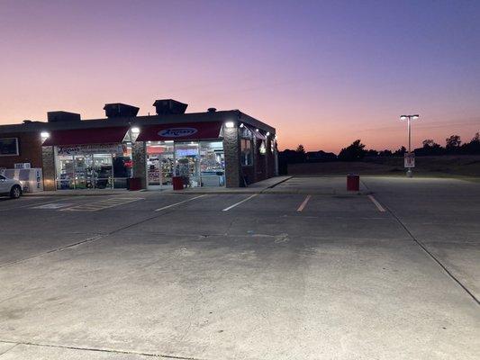 view of gas station from fuel dispensers, facing westward
