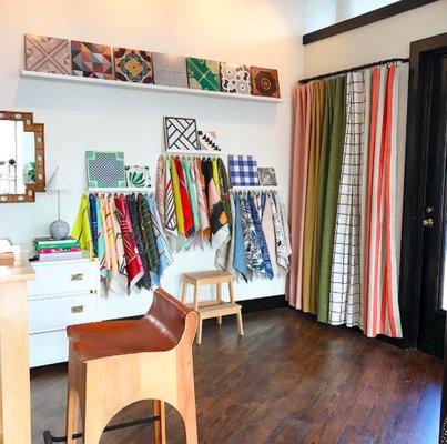 Designer fabric, wood and cement tiles, and curtain panels in multiple lengths.