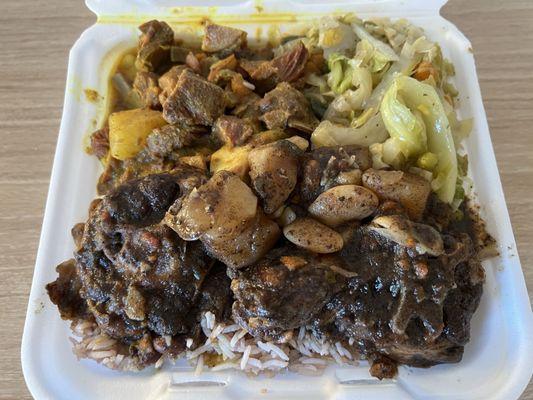 Oxtail & Curry Goat combo with rice and beans.