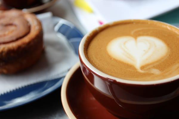 Soy latte and a cinnamon bun.