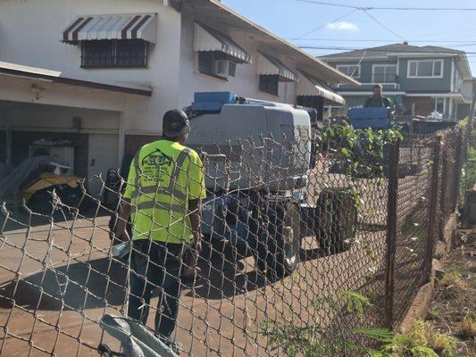Moving construction equipment around on the residential zoned property they illegally use as construction baseyard. Active lawsuit.