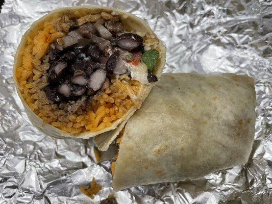 Steak burrito with onion, cilantro, rice, black beans and sour cream
