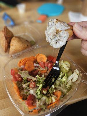 Salad accompanied by samosas