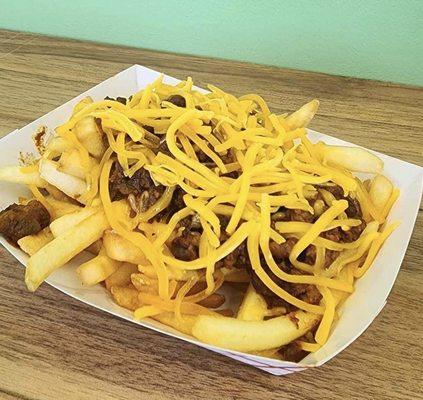 Pearl's chili fries are a must-try! Perfectly crispy fries topped with savory chili and melted cheese. Pure deliciousness in every bite!