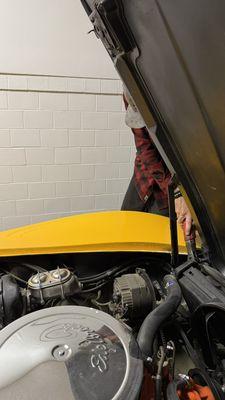 Taking the hood off a 1969 Corvette to perform an install on a AC unit for a customer.